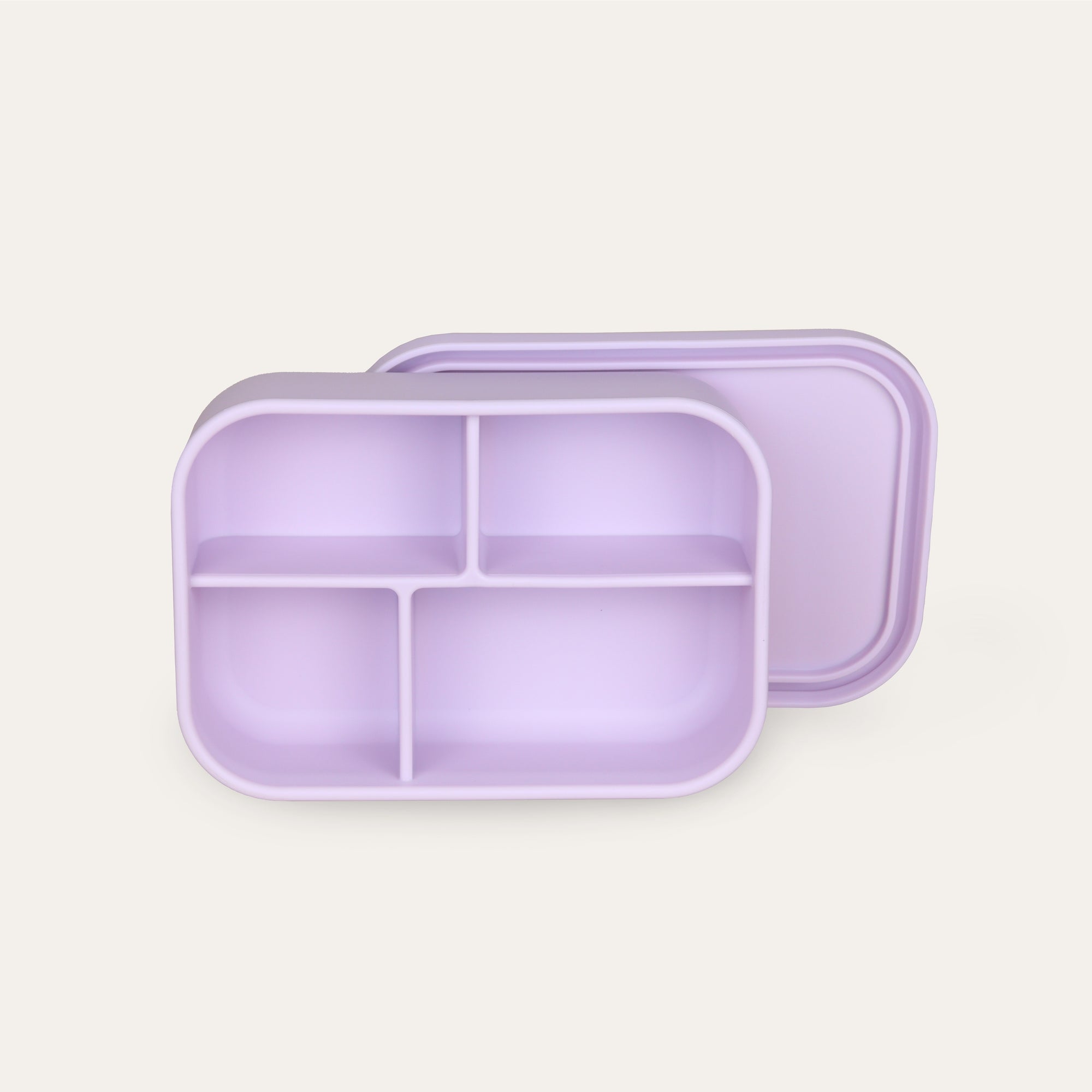 Purple divided lunch box on a light beige background
