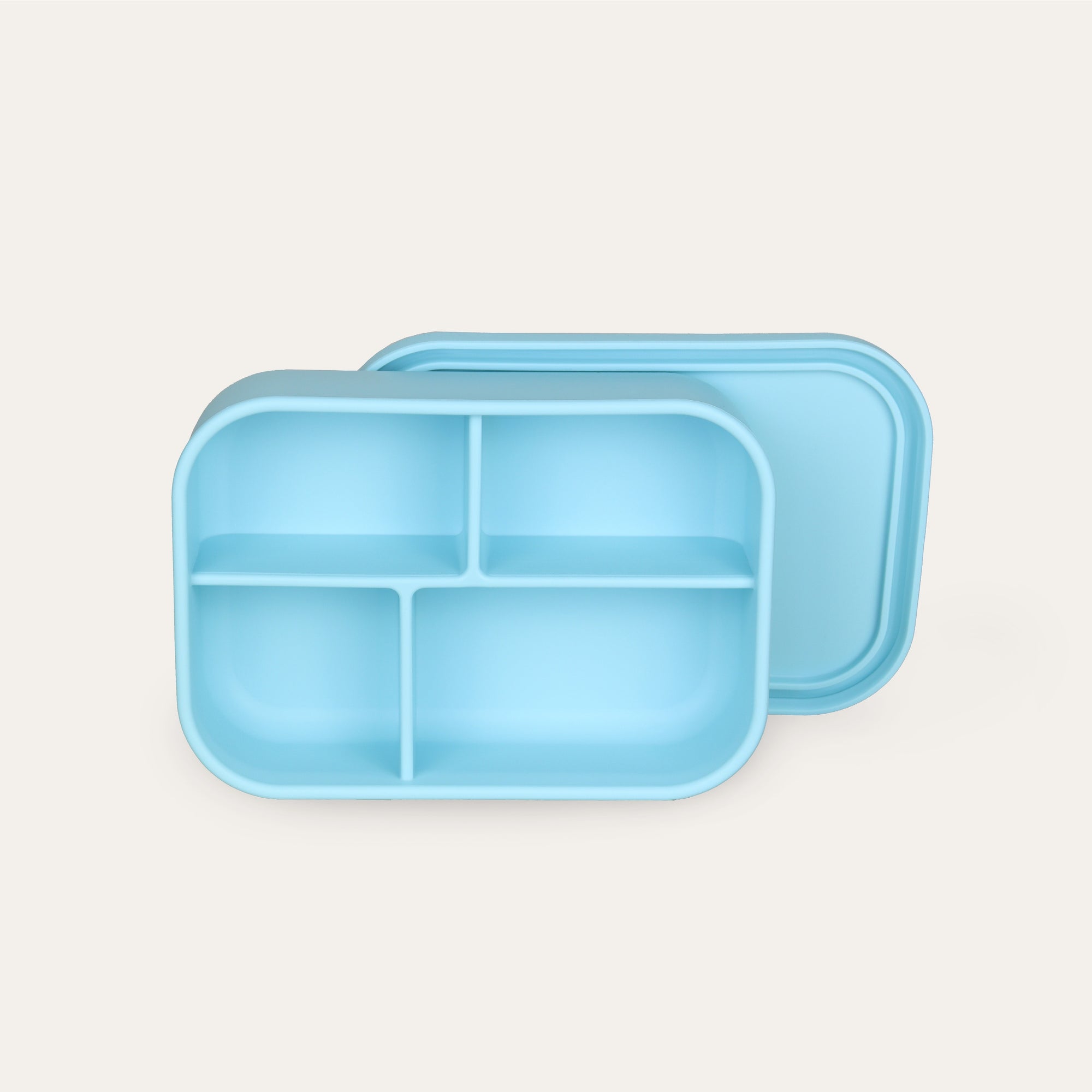 Light blue bento box with compartments on a light gray background