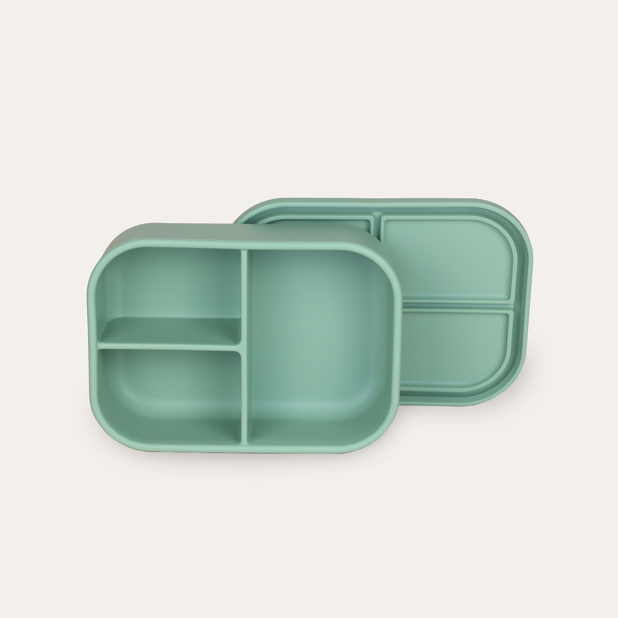 Green divided lunch box on a white background